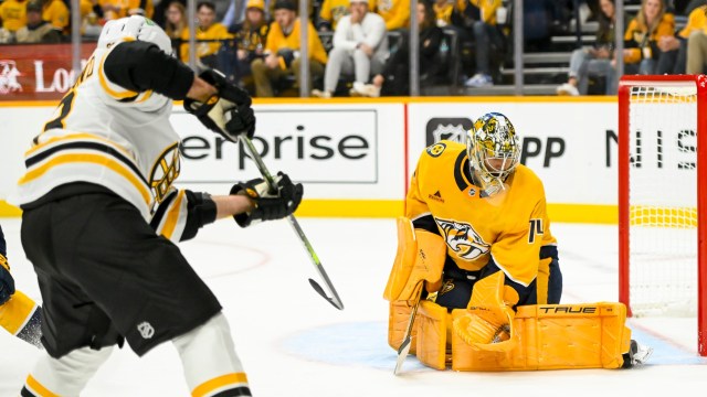 Boston Bruins forward Elias Lindholm and Nashville Predators goaltender Juuse Saros