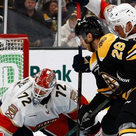 Boston Bruins forward Elias Lindholm and Florida Panthers goaltender Sergei Bobrovsky and defenseman Niko Mikkalo