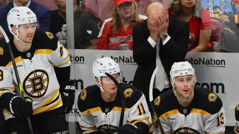 Boston Bruins coach Jim Montgomery and players Max Jones, Trent Frederic and Charlie Coyle