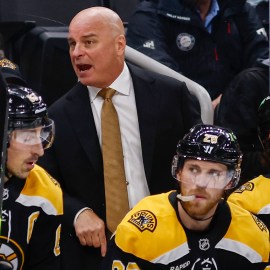 Boston Bruins head coach Jim Montgomery and forwards Brad Marchand, Elias Lindholm and Pavel Zacha