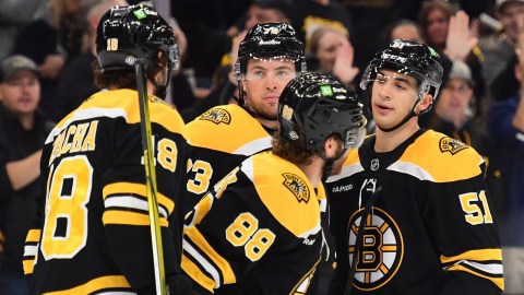 Boston Bruins forwards Pavel Zacha, David Pastrnak and Matthew Poitras and defenseman Charlie McAvoy