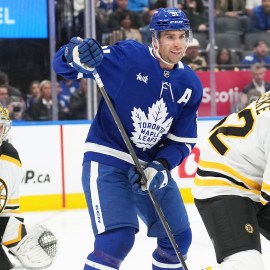 Boston Bruins defenseman Andrew Peeke and goaltender Jeremy Swayman and Toronto Maple Leafs forward John Tavares