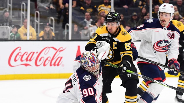 Boston Bruins forward Brad Marchand and Columbus Blue Jackets goalie Elvis Merzlikins