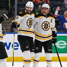 Boston Bruins teammates Brad Marchand, Pavel Zacha and David Pastrnak