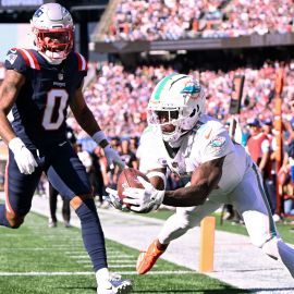 New England Patriots cornerback Christian Gonzalez and Miami Dolphins wide receiver Tyreek Hill