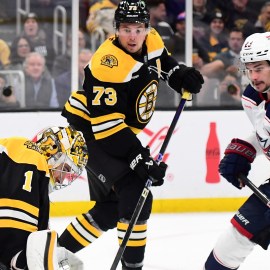 Boston Bruins goaltender Jeremy Swayman and defenseman Charlie McAvoy and Columbus Blue Jackets center Sean Monahan