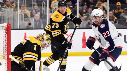 Boston Bruins goaltender Jeremy Swayman and defenseman Charlie McAvoy and Columbus Blue Jackets center Sean Monahan