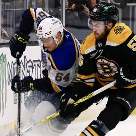 Boston Bruins forward Justin Brazeau and St. Louis Blues defenseman Corey Schueneman