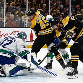 Boston Bruins forward Mark Kastelic and Vancouver Canucks goalie Kevin Lankinen