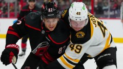 Boston Bruins forward Max Jones and Carolina Hurricanes forward Jesperi Kotkaniemi