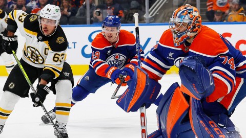 Boston Bruins forward Brad Marchand and Edmonton Oilers goaltender Stuart Skinner