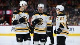 Boston Bruins forwards Charlie Coyle, Elias Lindholm and Brad Marchand