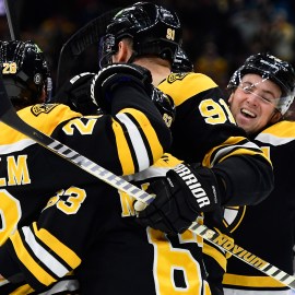 Boston Bruins forwards Elias Lindholm and Brad Marchand, defensemen Nikita Zadorov and Charlie McAvoy