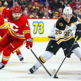 Boston Bruins forward Marc McLaughlin and Calgary Flames defenseman Rasmus Andersson