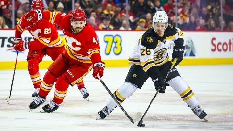 Boston Bruins forward Marc McLaughlin and Calgary Flames defenseman Rasmus Andersson