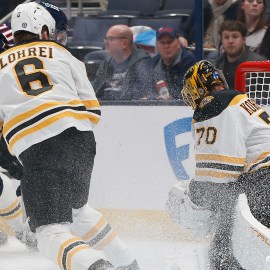 Boston Bruins defenseman Mason Lohrei and goaltender Joonas Korpisalo