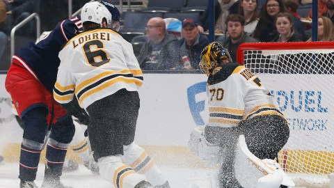 Boston Bruins defenseman Mason Lohrei and goaltender Joonas Korpisalo