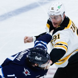 Boston Bruins defenseman Nikita Zadorov and Winnipeg Jets forward Adam Lowry