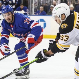 Boston Bruins forward Brad Marchand and New York Rangers forward Sam Carrick