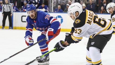 Boston Bruins forward Brad Marchand and New York Rangers forward Sam Carrick