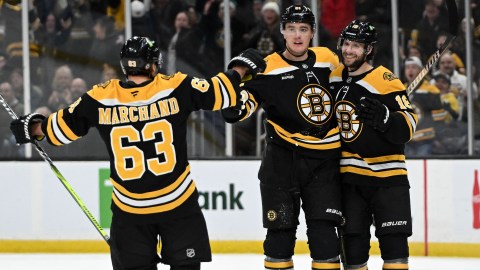 Boston Bruins forwards Brad Marchand and Pavel Zacha and defenseman Nikita Zadorov