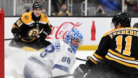 Boston Bruins forwards Trent Frederic and Matthew Poitras and Tampa Bay Lightning goaltender Andrei Vasilevskiy